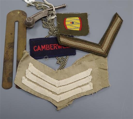 A Bosuns whistle, button stick, two military stripes and two
